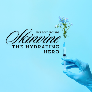 image of a blue gloved hand holding a syringe upward and a small bunch of flower sprouting from the needle against a blue background. Has the title "Introducing Skinvine: The Hydrating Hero"